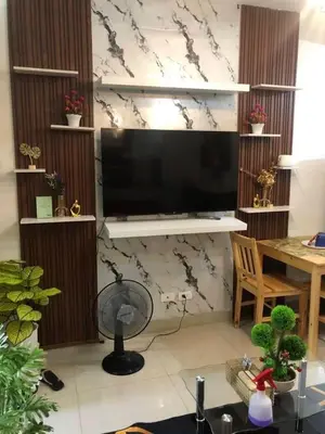 a living room with a flat screen tv on a wall at 3M Staycation in Manila