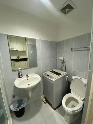 a small bathroom with a toilet and a sink at Sea Residences MOA Pasay City - Reynil in Manila