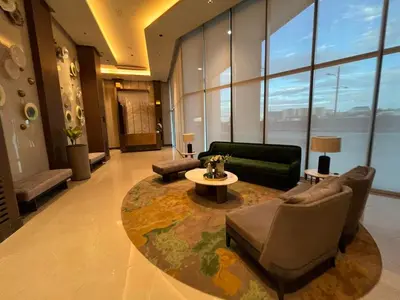a living room with a couch and chairs and a table at Gentry Manor Balcony Sea View WiFi Netflix Near Airport Okada 8B in Manila