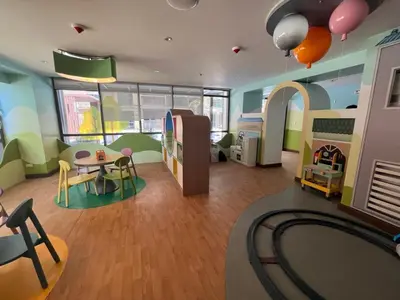 a room with a playroom with a table and chairs at Gentry Manor Balcony Sea View WiFi Netflix Near Airport Okada 8B in Manila