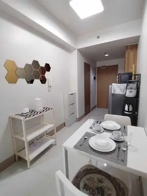 a kitchen with a table with plates on it at JL shore Staycation in Manila