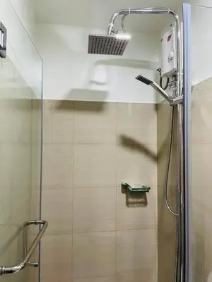 a shower with a glass door in a bathroom at Pasay Condo near MOA, NAIA, CBD and Casinos in Manila