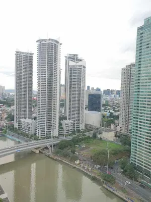 a city with tall buildings and a bridge over a river at Hotel Apartment Suite near Makati in Manila