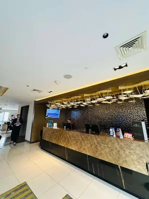 a lobby of an airport with a check in counter at Hotel Apartment Suite near Makati in Manila
