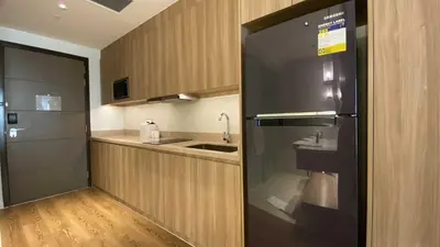a kitchen with a sink and a refrigerator at Hotel Apartment Suite near Makati in Manila