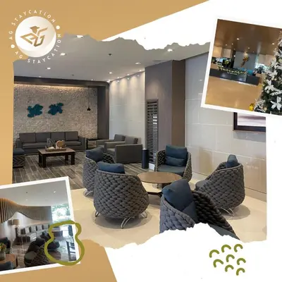 a lobby with couches and chairs in a building at 1br with Balcony near MOA unit 3 in Manila