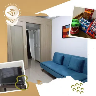 a living room with a blue couch in a room at 1br with Balcony near MOA unit 3 in Manila