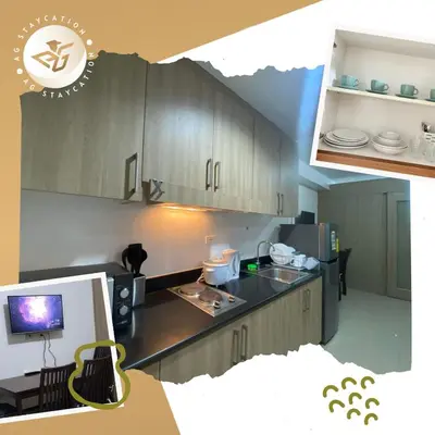 a kitchen with wooden cabinets and a black counter top at 1br with Balcony near MOA unit 3 in Manila