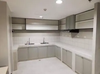 a kitchen with white cabinets and sinks in it at Manila Real Residences 8A in Manila