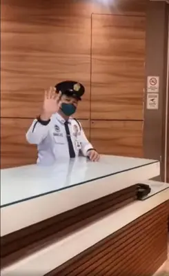 a man wearing a mask standing behind a counter at Manila Real Residences 8A in Manila