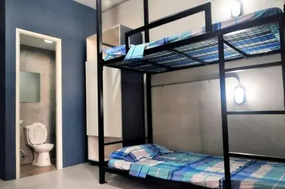 a bedroom with two bunk beds and a toilet at Manila Real Residences 8C in Manila