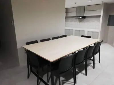 a dining room with a table and black chairs at Manila Real Residences 8C in Manila