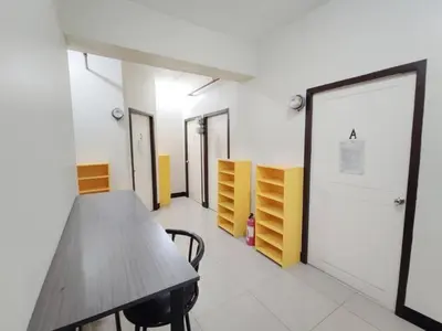 a conference room with a wooden table and chairs at Manila Real Residences 8C in Manila