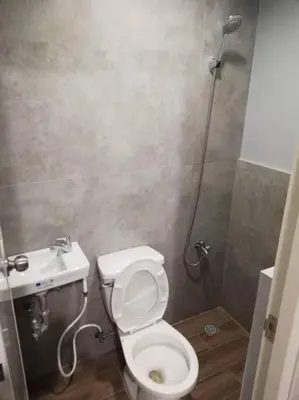 a bathroom with a toilet and a sink at Manila Real Residences 8C in Manila