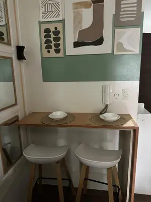 a small table with two stools and a lamp at Affordable Ayala Makati 1BR Condo in Manila