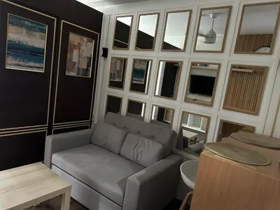 a living room with a couch and a table at Affordable Ayala Makati 1BR Condo in Manila