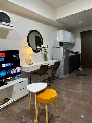 a kitchen with a table and chairs and a mirror at King-size Bed Makati Condo in Manila