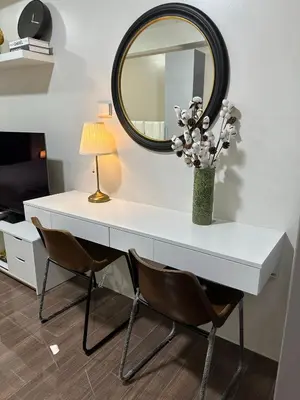 a white desk with two chairs and a mirror at King-size Bed Makati Condo in Manila