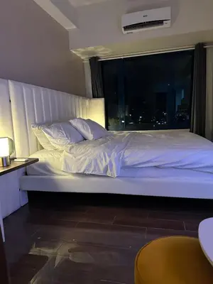 a large bed in a room with a window at King-size Bed Makati Condo in Manila
