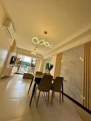 a dining room with a table and chairs at Condo in Taguig in Manila