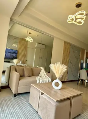 a living room with a couch and a table at Condo in Taguig in Manila