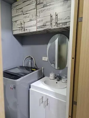 a bathroom with a sink and a mirror at Kaths Place in Manila
