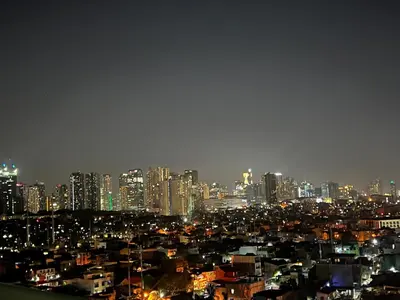 a view of a city at night with buildings at Kaths Place in Manila