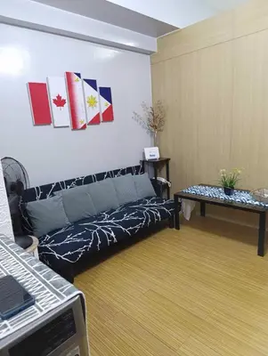 a living room with a couch and a table at Kaths Place in Manila