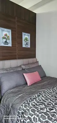a bedroom with a large bed with two pictures on the wall at Relaxing Chic Hotel Like with Manila Bay view in Manila