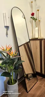 a mirror and a potted plant on a table at Relaxing Chic Hotel Like with Manila Bay view in Manila
