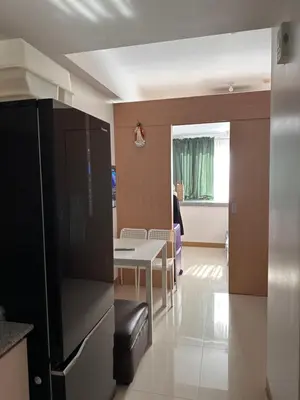 a kitchen and dining room with a table and a refrigerator at RKChillescapes in Manila