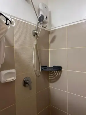 a shower with a shower head in a bathroom at RKChillescapes in Manila