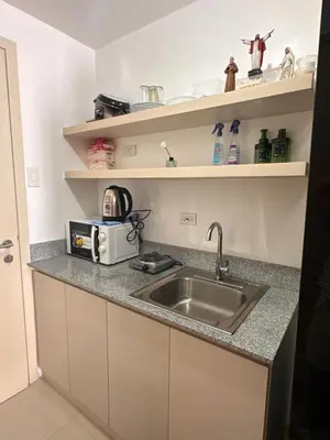 a kitchen with a sink and a toaster on a counter at RKChillescapes in Manila