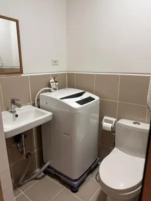 a bathroom with a toilet and a sink at RKChillescapes in Manila