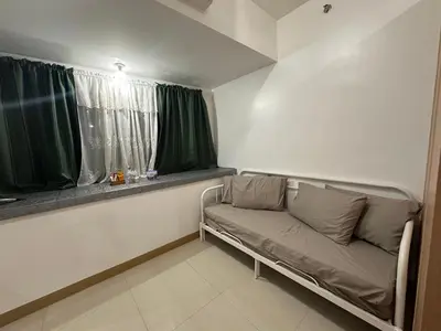 a room with a couch in front of a window at RKChillescapes in Manila