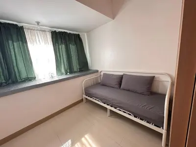 a small room with a couch and two windows at RKChillescapes in Manila
