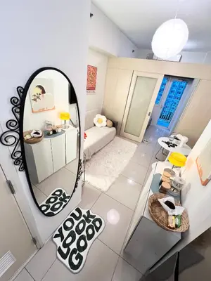 a small room with a mirror and a couch at Fun Pop-Art Inspired Makati Studio in Manila