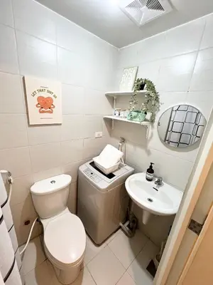 a bathroom with a toilet and a sink at Fun Pop-Art Inspired Makati Studio in Manila