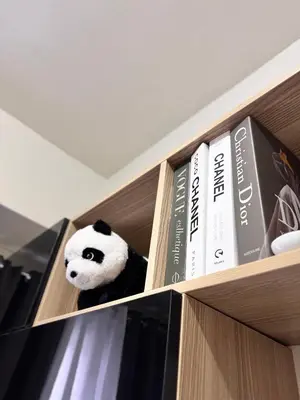 a stuffed panda bear is sitting on a book shelf at Hearth of Ember at Shore 3 in Manila