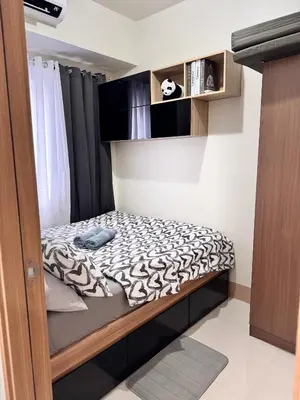a small bedroom with a bed with a black and white blanket at Hearth of Ember at Shore 3 in Manila