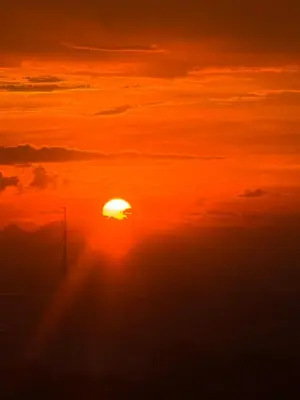 an orange sunset with the sun in the sky at Green 2 - Gems Suite in Dasmariñas