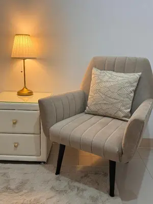 a chair sitting next to a desk with a lamp at Green 2 - Gems Suite in Dasmariñas