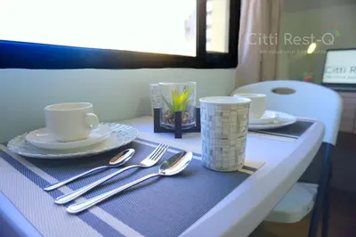 a table with plates and utensils on a table at Studio City Alabang Pool Access Free for 2 Wifi & Netflix SC1 in Manila