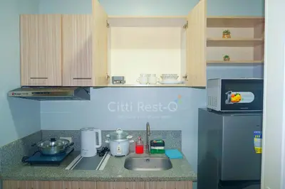 a kitchen counter with a sink and a microwave at Studio City Alabang Pool Access Free for 2 Wifi & Netflix SC1 in Manila