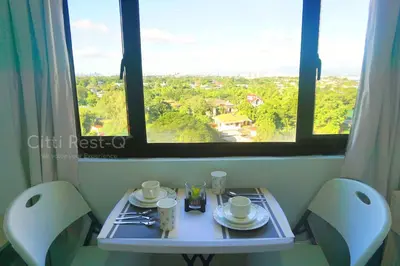 a table and two chairs with a table and a window at Studio City Alabang Pool Access Free for 2 Wifi & Netflix SC1 in Manila