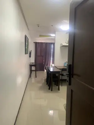 a hallway with a table and a dining room at Birch Tower Malate Accommodation by T&T in Manila