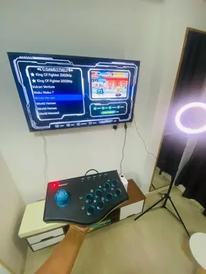 a person holding a remote control in front of a tv at Sole Sister Azure Staycation in Manila