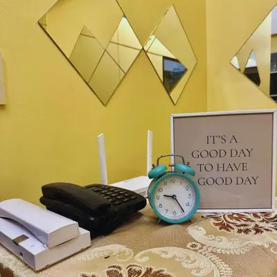 a alarm clock sitting on top of a table with a sign at Cozy Stay Near BGC & Airport in Manila