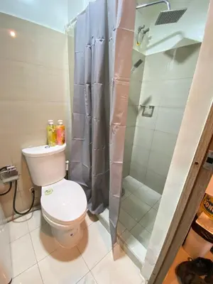 a bathroom with a toilet and a shower at La Casa de Maria in Manila