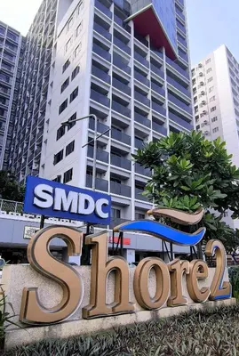 a large sign in front of a large building at La Casa de Maria in Manila